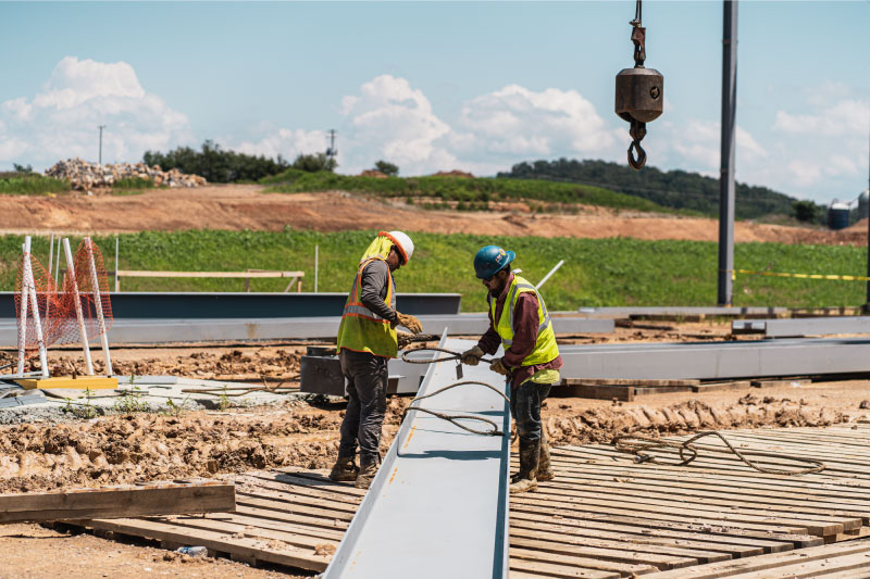 two Dean Steel employees work on a job site